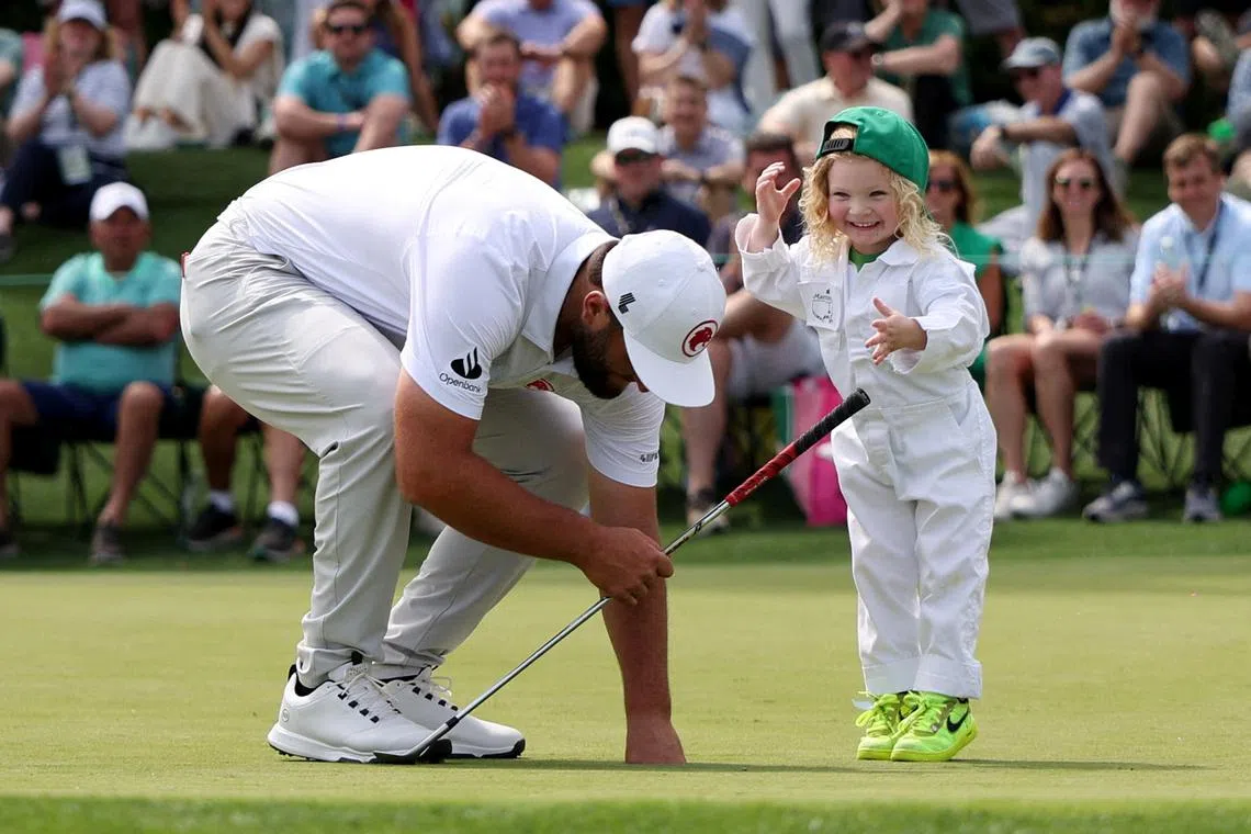 Spain's Jon Rahm with his son, Kepa on the 2nd hole during  the Masters golf competiton held at the Augusta National Golf Club, in Augusta, Georgia, US, on April 10, 2024 