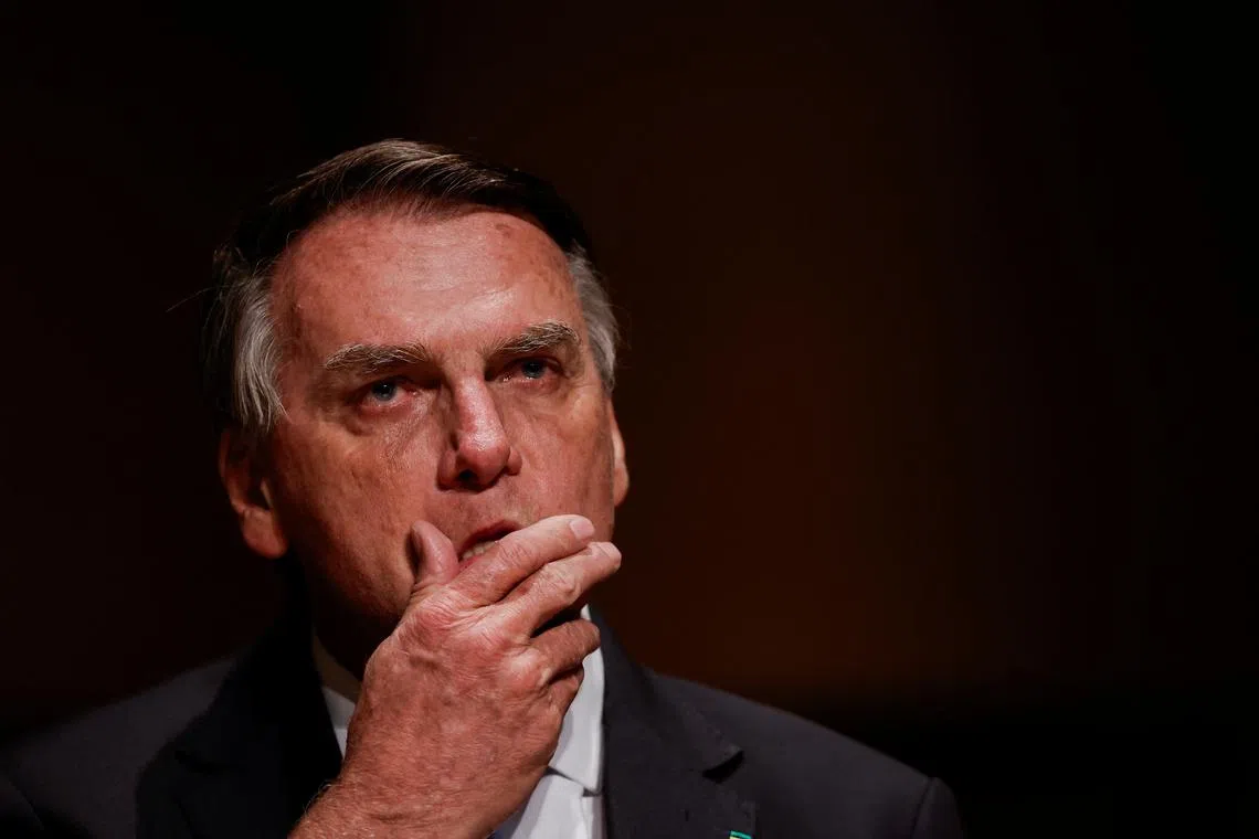 FILE PHOTO: Brazil's former President Jair Bolsonaro reacts at an event at the Municipal Theatre in Sao Paulo, Brazil March 25, 2024. REUTERS/Amanda Perobelli/File Photo