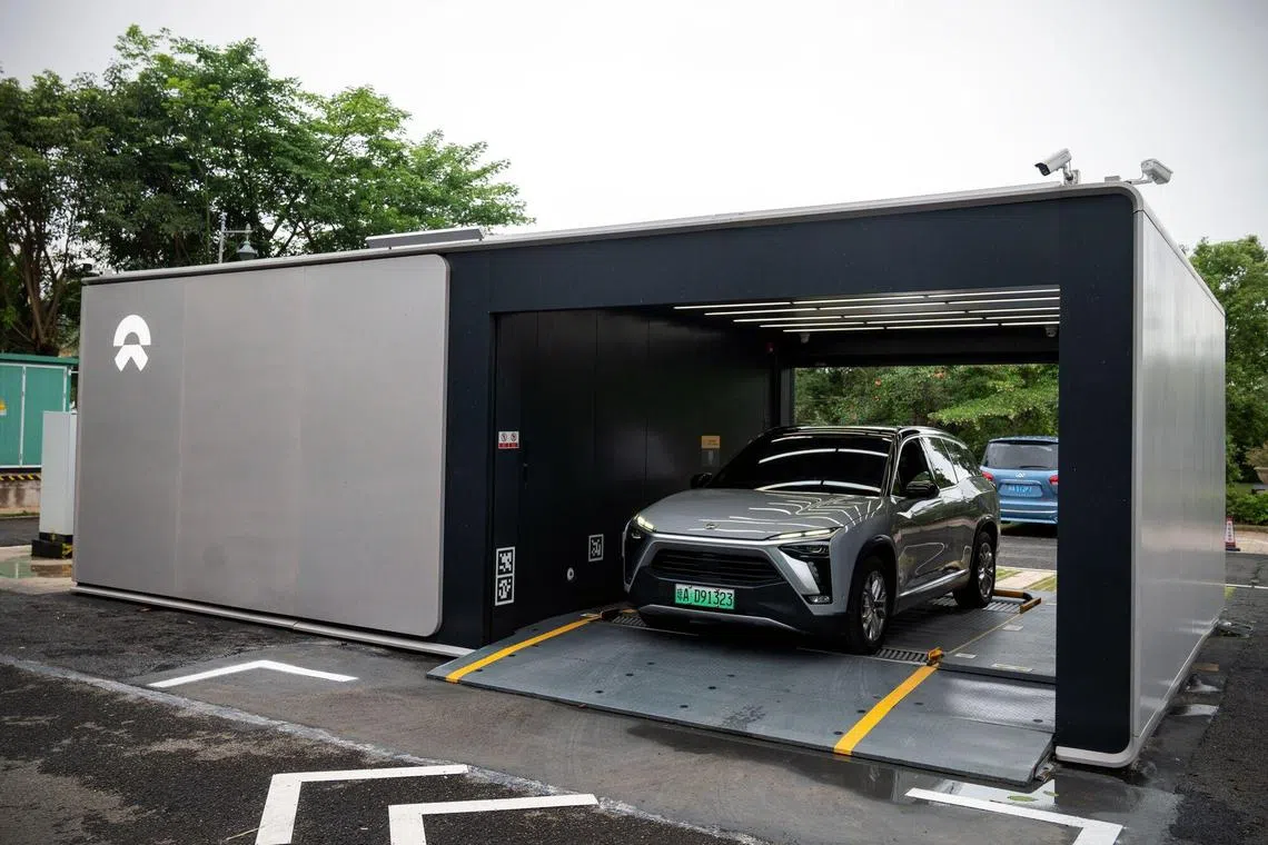 An EV swaps battery at a Nio battery swapping station in Haikou, Hainan Province, China, on Tuesday, May 9, 2023. Hainan is the first and only place in China to set a goal to end the sale of fossil fuel cars by 2030 and have EVs and hybrids account for 45% of the island’s fleet. Photographer: Bloomberg