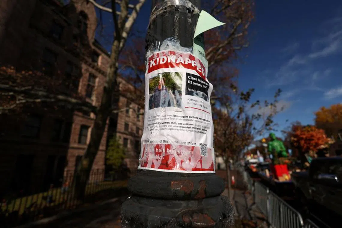 A poster featuring a picture with the word \"kidnapped\" hangs, amid the ongoing conflict between Israel and the Palestinian Islamist group Hamas, from a pole by the Macy's Thanksgiving Day Parade inflation area the day before the Macy's Thanksgiving Day Parade in New York City, U.S., November 22, 2023.  REUTERS/Shannon Stapleton