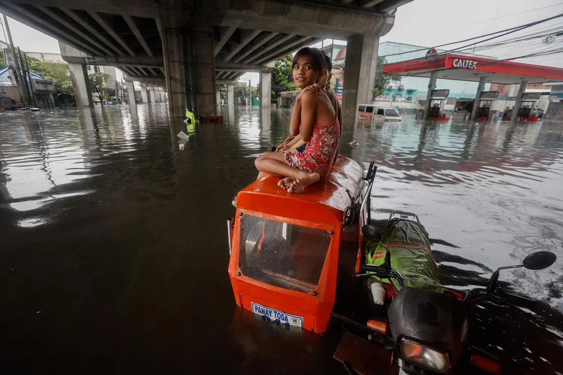 A resident sitting atop a tricycle amid flooding following monsoon rainfall in Quezon City, Metro Manila, Philippines, 24 July 2024. Monsoon rains caused by typhoon Gaemi resulted in flooding in Metro Manila and nearby provinces, as it is forecast to be headed in the general direction of Taiwan as it moves out of Philippine territory. EPA-EFE/ROLEX DELA PENA