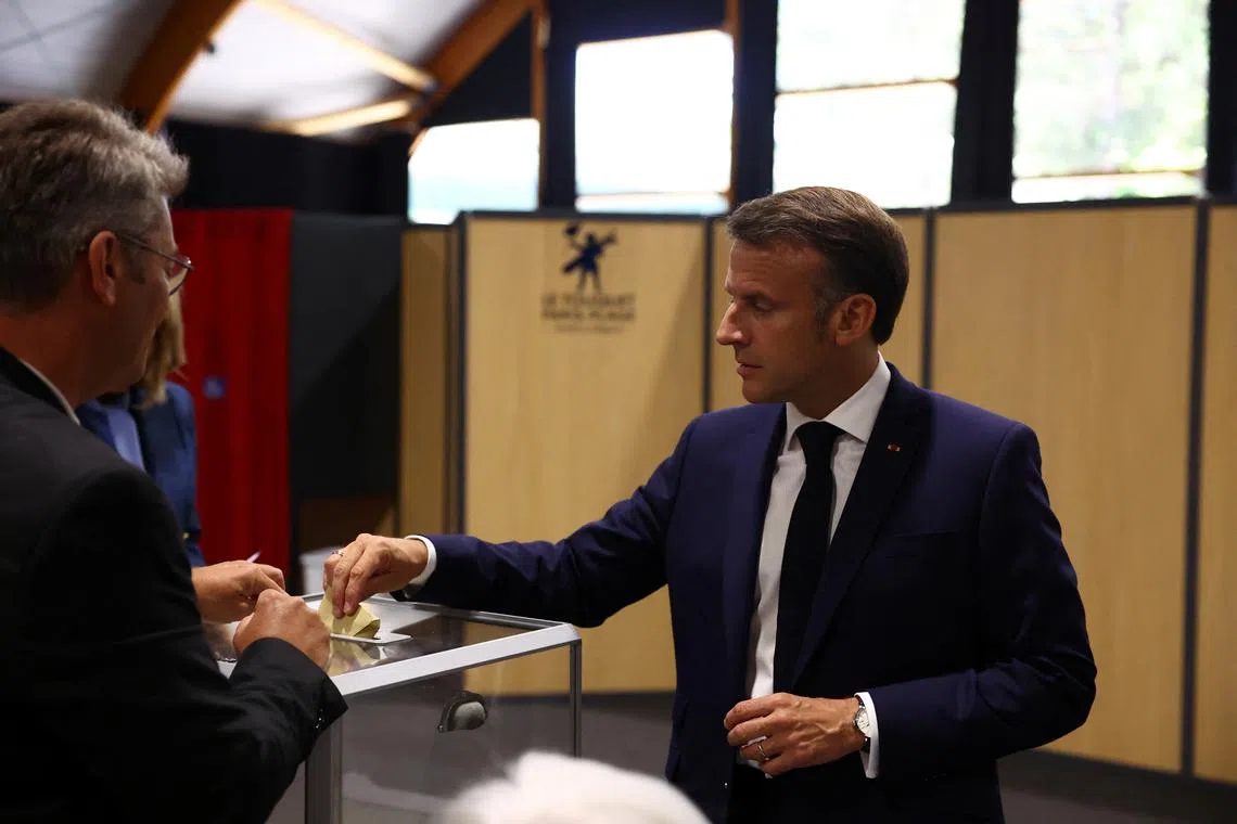 French President Emmanuel Macron votes during the European Parliament election at a polling station in Le Touquet-Paris-Plage, France, June 9, 2024. REUTERS/Hannah McKay/Pool