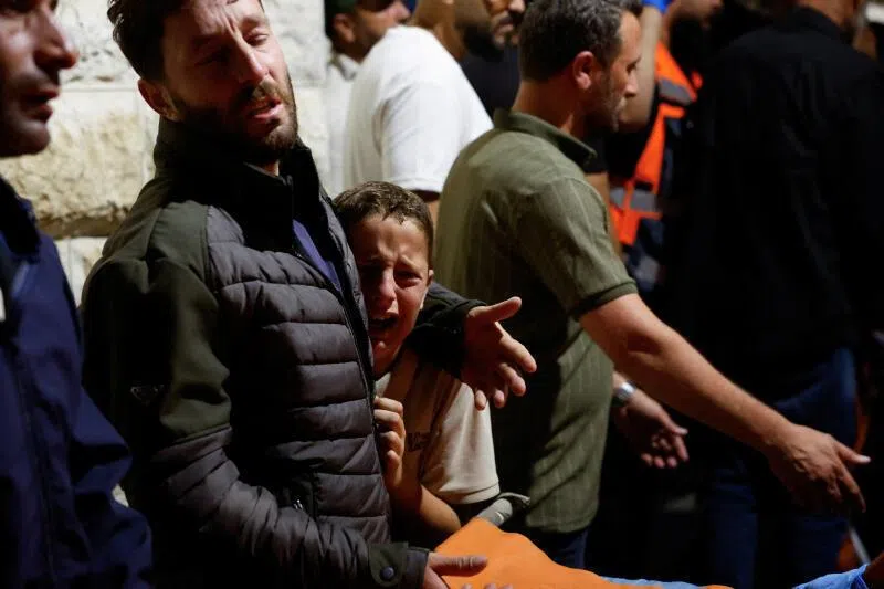 Palestinians react next to the bodies of Palestinians, who were killed in a deadly shooting incident near the village of Tal in Nablus, West Bank, during their funeral on July 25.