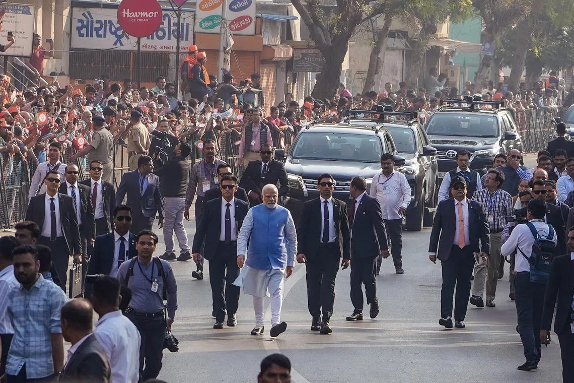 Indian Prime Minister Narendra Modi walks to cast his vote in Ahmadabad, Gujarat, bastion of his ruling party.