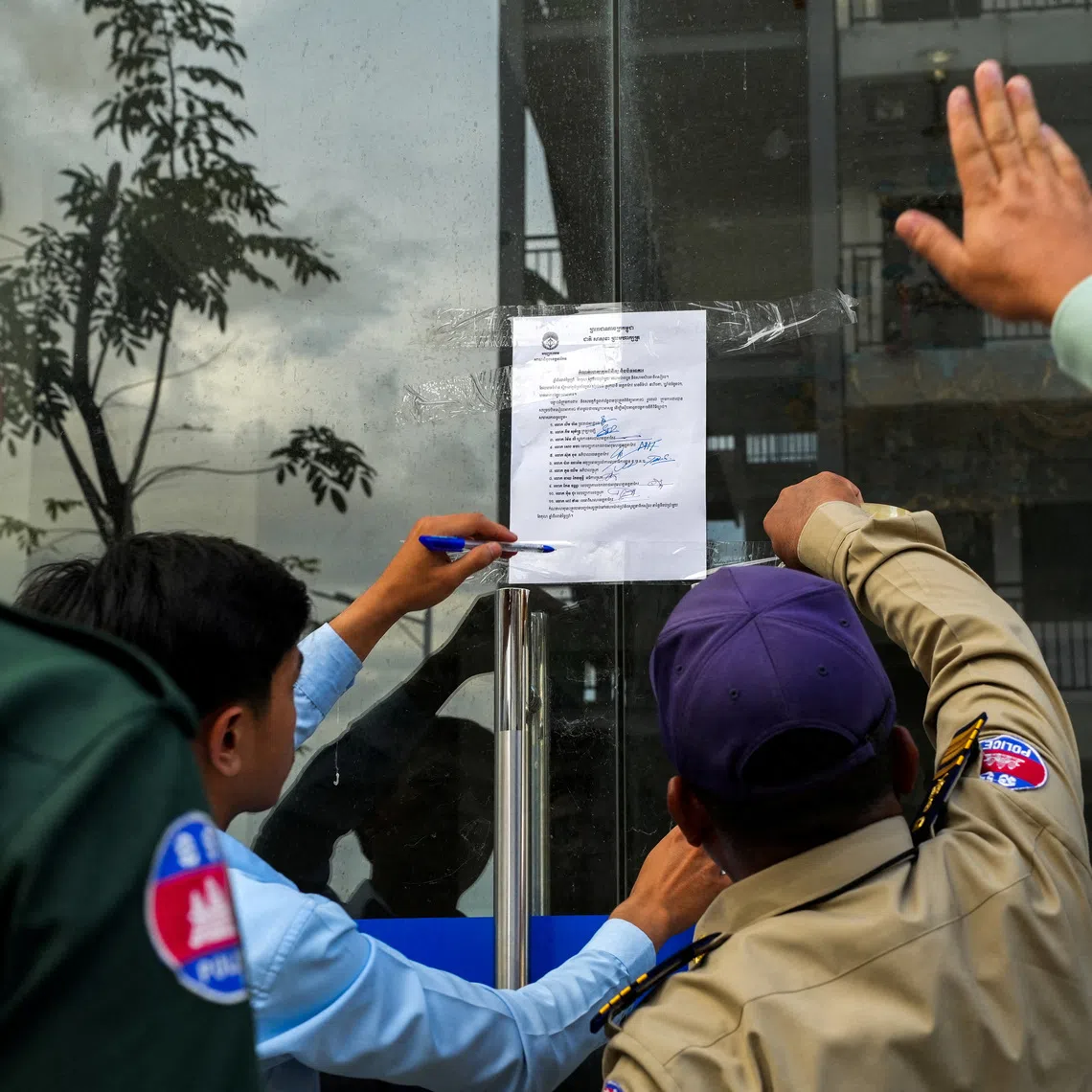 Authorities placing an order at a building inside a compound in Cambodia's Takeo province in October after the death of a South Korean student in the country.