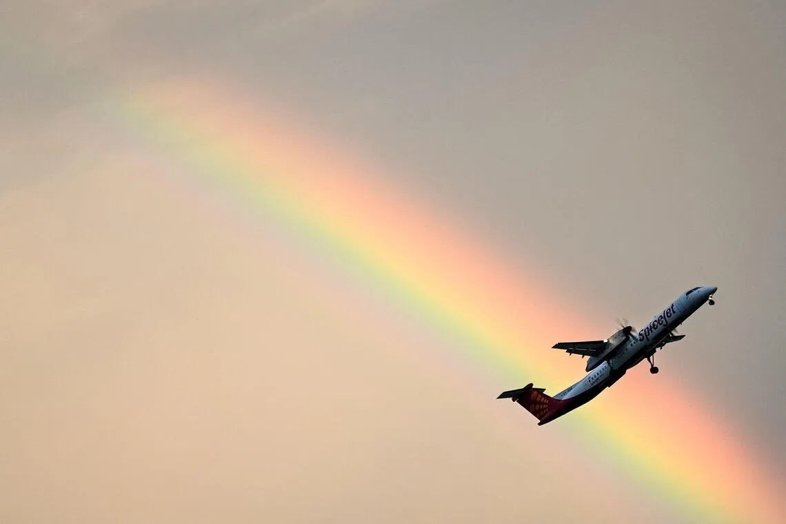 A SpiceJet aircraft flying past a rainbow during the dusk in Chennai, on Sept 29, 2025. 