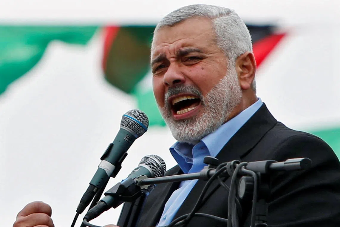 FILE PHOTO: Ismail Haniyeh, prime minister of the Hamas Gaza government, talks to his supporters during a Hamas rally marking the anniversary of the death of its leaders killed by Israel, in Gaza City March 23, 2014. REUTERS/Mohammed Salem/File Photo