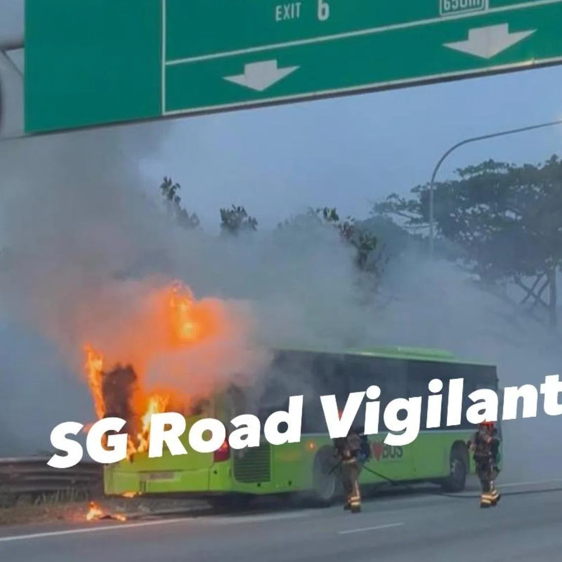 A photo uploaded on social media shows firefighters putting out a fire on the rear of a green bus that had stopped on the side of the road.