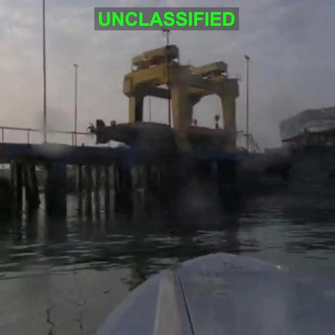 A US one-way attack surface drone approaches its target, a submarine and ship maintenance facility, in Bandar Abbas, Iran, as seen in this screengrab released July 13.