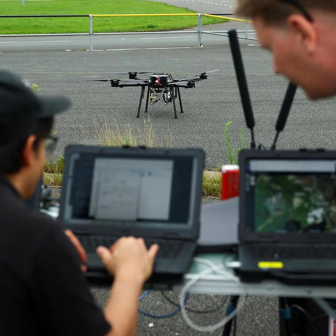 Engineers testing commands on the AI-powered Nexus system during flight tests with multiple drones in the Netherlands on Sept 30.