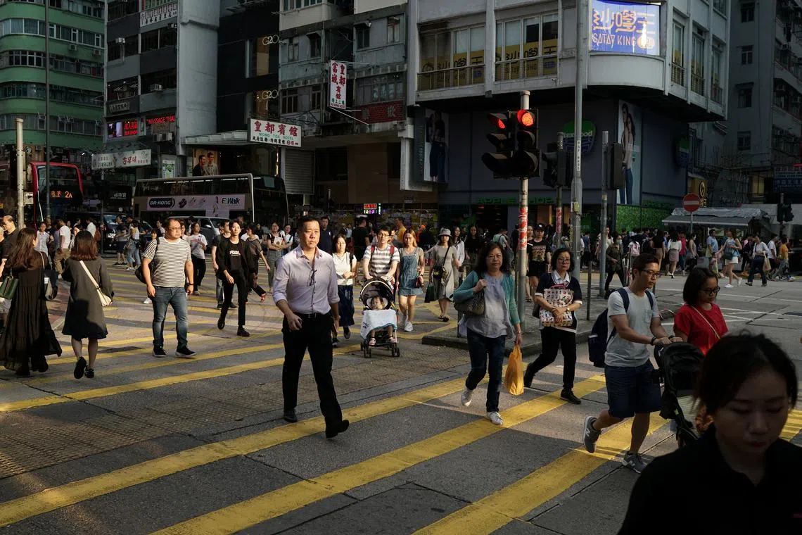 People walk in a street in Hong Kong, China October 17, 2019. REUTERS/Umit Bektas/ File Photo