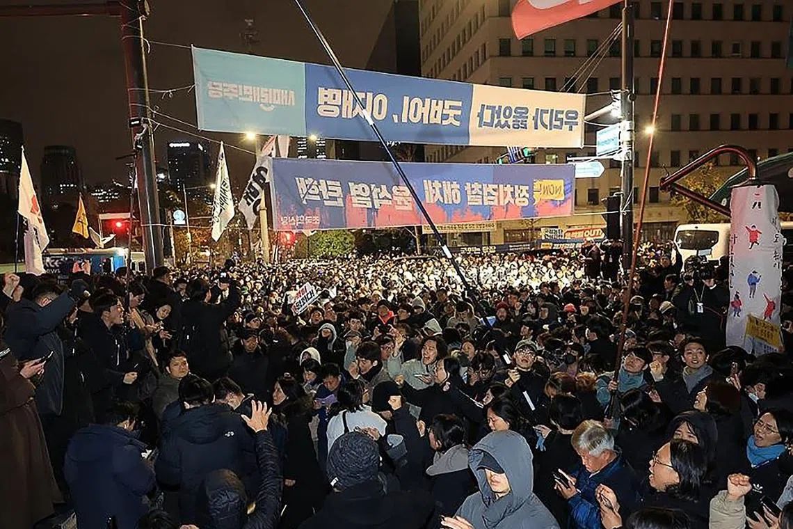 People gathering in front of the National Assembly in Seoul on Dec 4, 2024, after South Korea President Yoon Suk Yeol declared emergency martial law. 