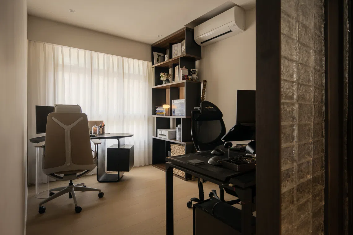 A glass block divider lets light into the study, separating spaces while preserving openness. 
