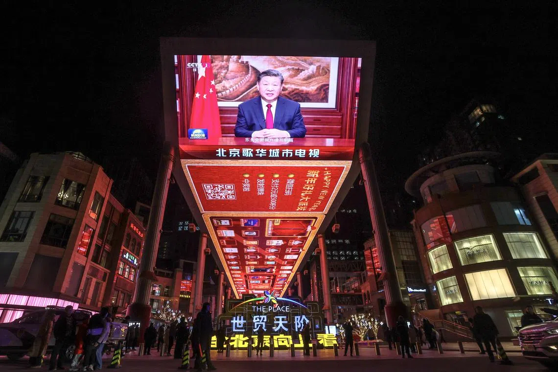 A broadcast of Chinese President Xi Jinping delivering his New Year's speech in Beijing on Dec 31.
