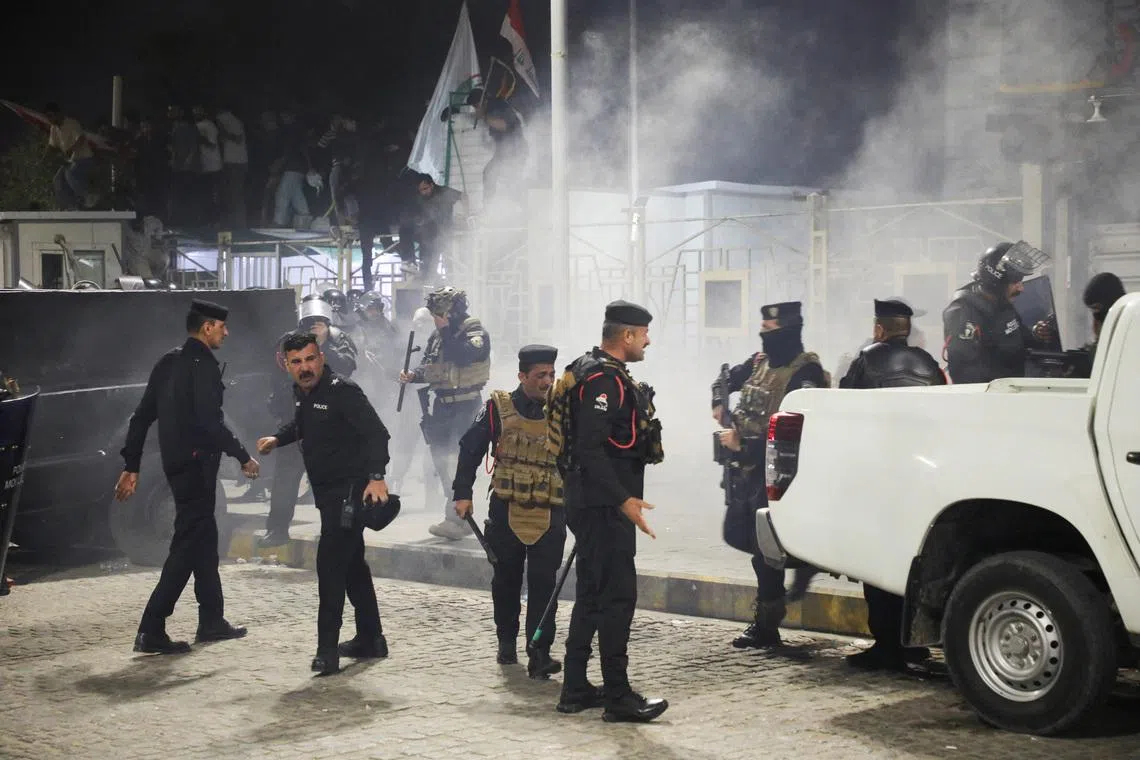 Iraqi security forces gather outside the Kuwaiti consulate during a protest following rockets fired from the direction of Kuwait that hit a house in Khor al-Zubair, Basra, Iraq, April 7, 2026. REUTERS/Mohammed Aty