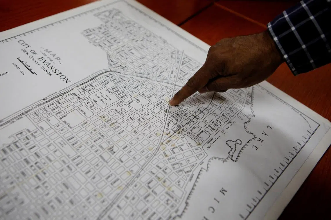 FILE PHOTO: Community historian Morris “Dino” Robinson, who helped shape the Evanston’s reparations initiative, points to the borders of the Fifth Ward, which was the area of Evanston the city’s Black citizens were forced to move to due to redlining between 1919 and 1969, in Evanston, Illinois, U.S March 17, 2021. REUTERS/Eileen T. Meslar/File Photo