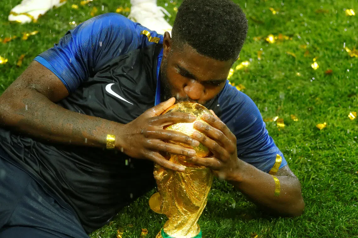 FILE PHOTO: Soccer Football - World Cup - Final - France v Croatia - Luzhniki Stadium, Moscow, Russia - July 15, 2018  France's Samuel Umtiti celebrates with the trophy after winning the World Cup  REUTERS/Kai Pfaffenbach/File Photo