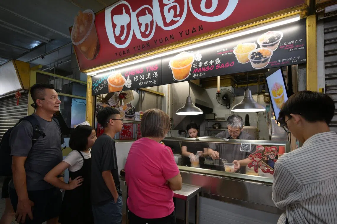hkpatrick15/ST20260716_202665400935/Ng Sor Luan/Singaporean Patrick Tay, 61, is an interior designer turned hawker. After spending years abroad in Beijing, he now runs hawker stall Tuan Tuan Yuan Yuan in Chinatown Complex selling desserts like Cheng Tng, Yuzu Ice and Mango Sago.  His daughter, Nichole Tay, 28, founder of storytelling social app Phases currently helps out at the stall.