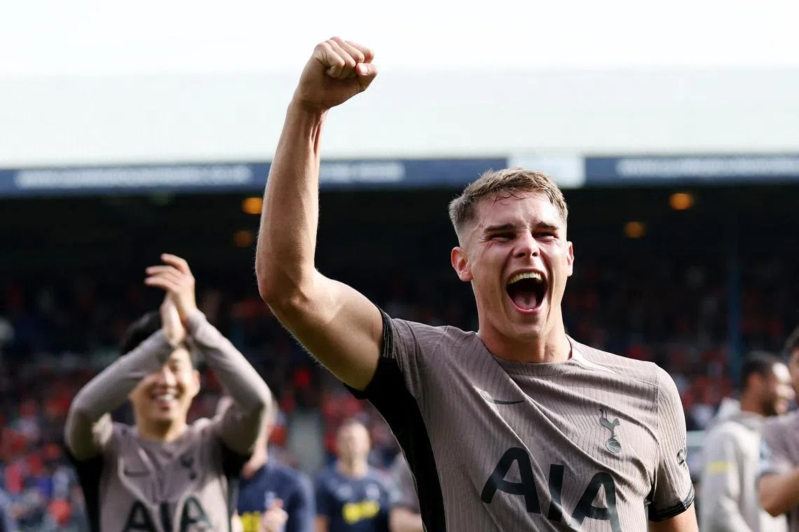 Tottenham Hotspur's Micky van de Ven celebrates with captain Son Heung-min after their win over Luton Town in October 2023.