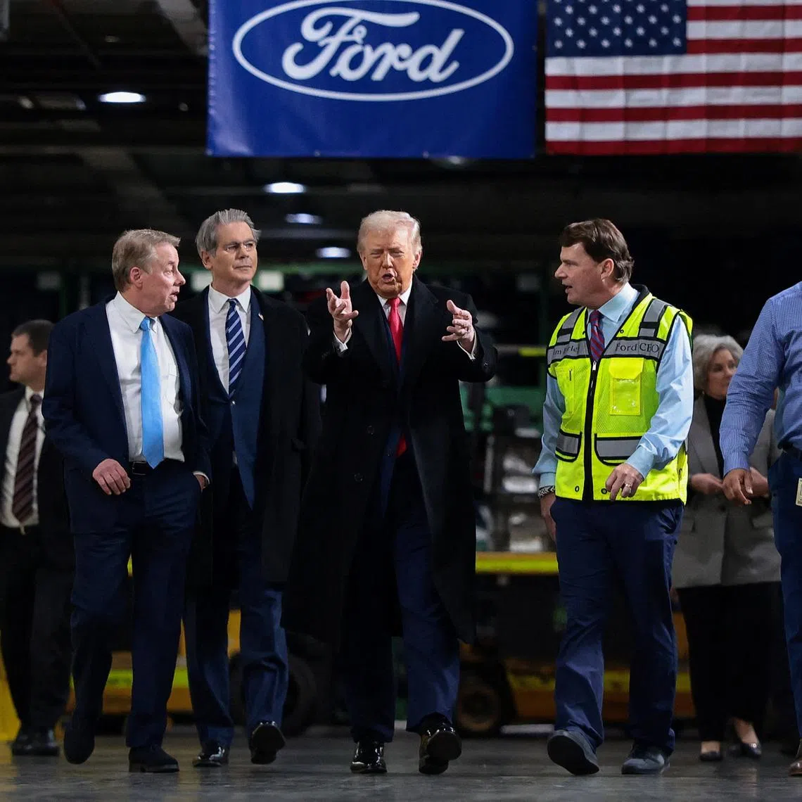 U.S. President Donald Trump walks with Treasury Secretary Scott Bessent, Bill Ford, Executive Chairman of Ford, Jim Farley, CEO of Ford and Corey Williams, Ford River Rouge Plant Manager, during President Trump's visit to a Ford production center in Dearborn, Michigan, U.S., January 13, 2026. REUTERS/Evelyn Hockstein
