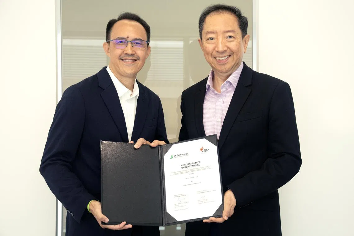 Singapore Badminton Association secretary general Collin Tham (left) and JK Technology executive director Eugene Ang at the Memorandum of Understanding signing.
