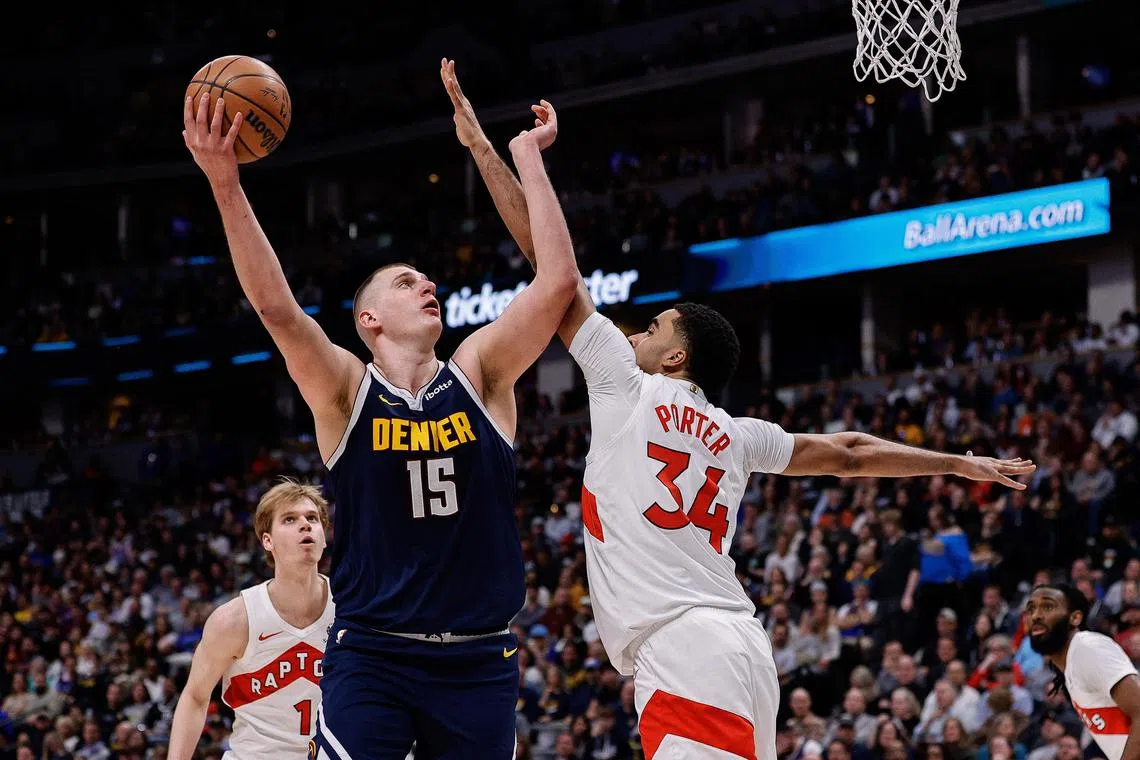 Denver Nuggets centre Nikola Jokic attempts a shot against Toronto Raptors centre Jontay Porter in the third quarter at Ball Arena.