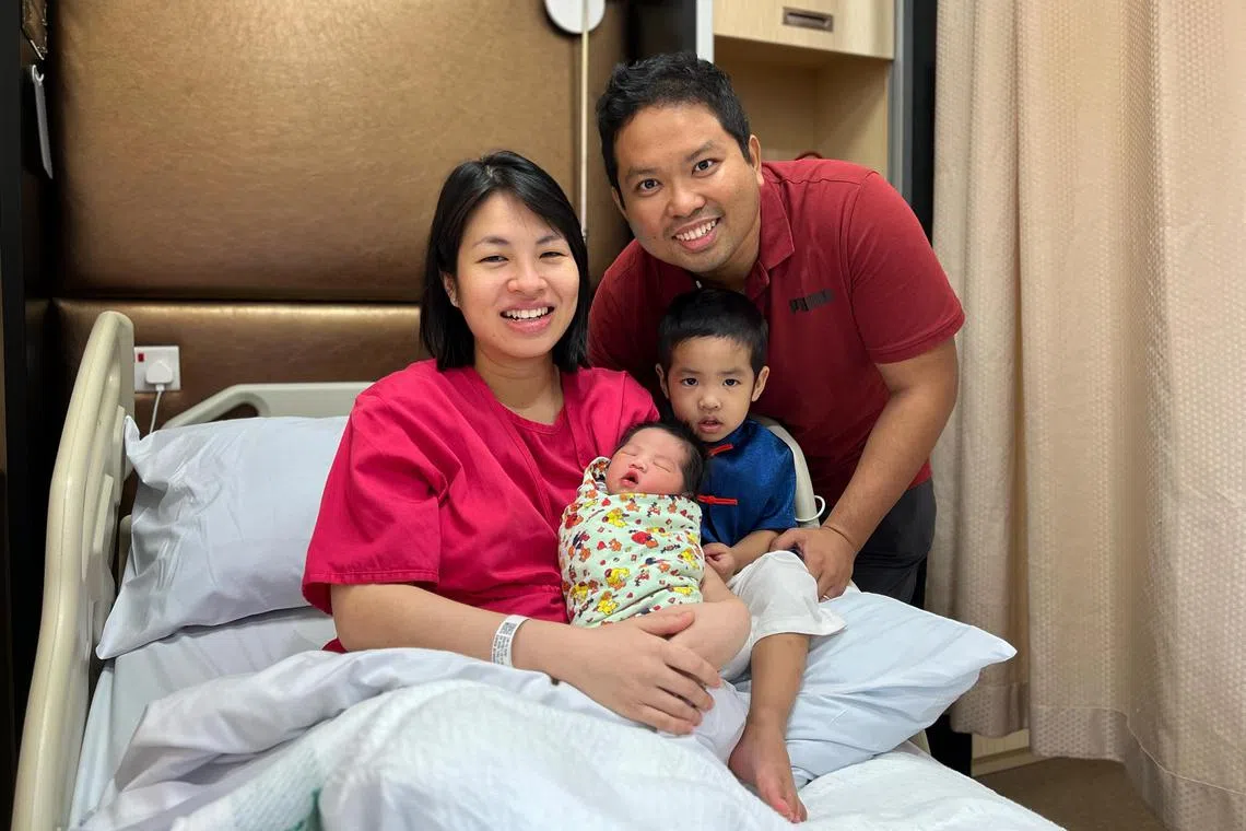 (Clockwise from left) Ms Yvonne Lim, 34-year-old content manager, with her husband Ezzad Fahmy, 36-year-old civil servant, son Ezra Shan, three, and newborn daughter Ezlea Shan at Parkway East Hospital. For Salma’s story. PHOTO: KEVIN LIM