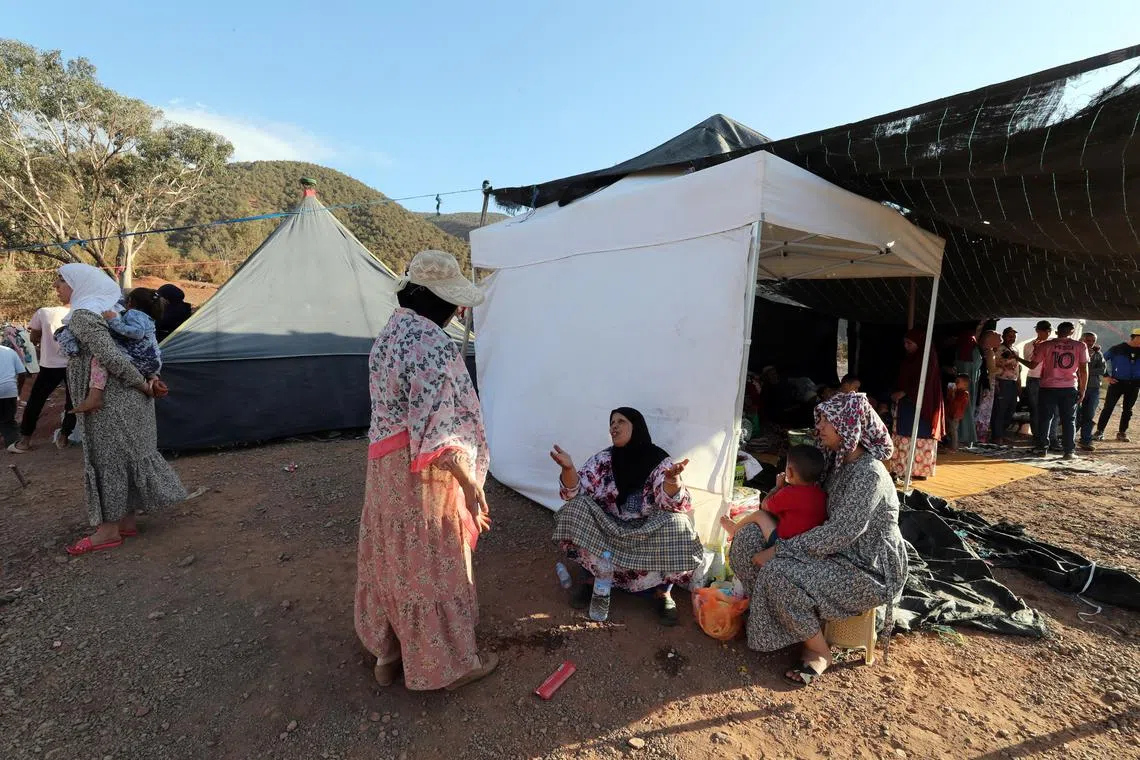A Moroccan family affected by a magnitude 6.8 earthquake at a camp in Ouirgane, south of Marrakech, on Sept 10.