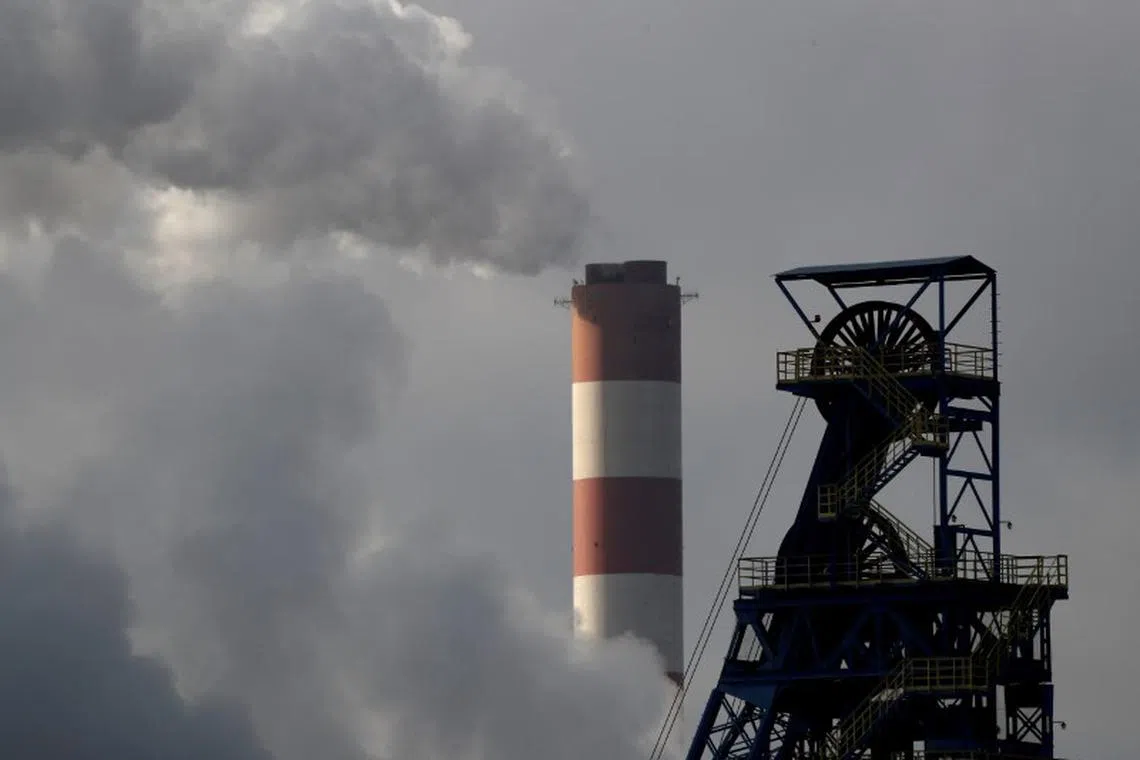 FILE PHOTO: a chimney at Laziska power station, a thermal power plant, is seen behind the Boleslaw Smialy coal mine in Laziska Gorne, Poland,  December 5, 2018. REUTERS/Kacper Pempel/File Photo