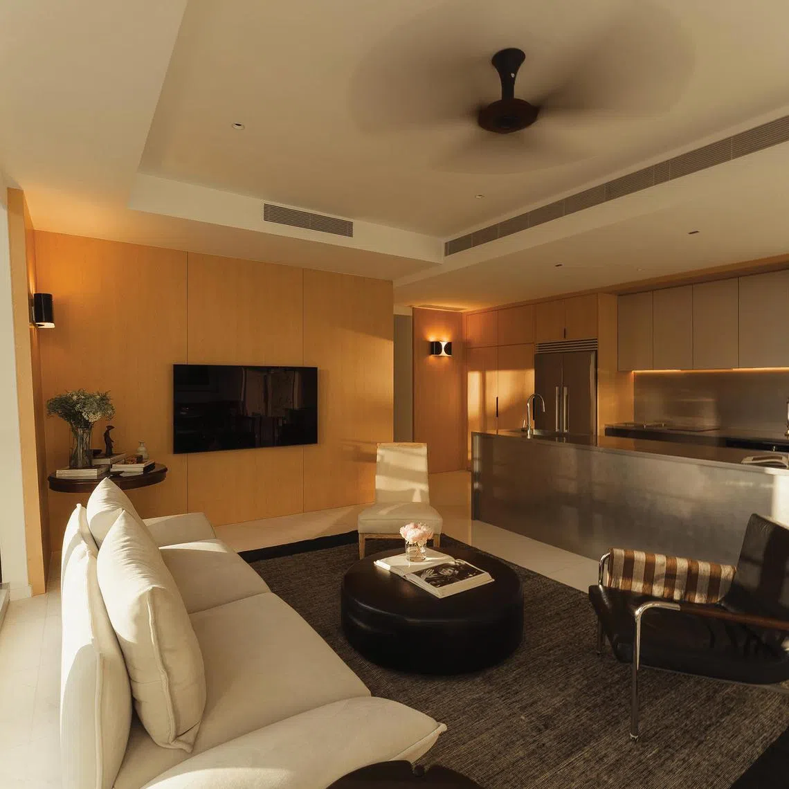 The warm, restrained palette of this apartment was inspired by the owners' holidays at the Park Hyatt Bangkok.