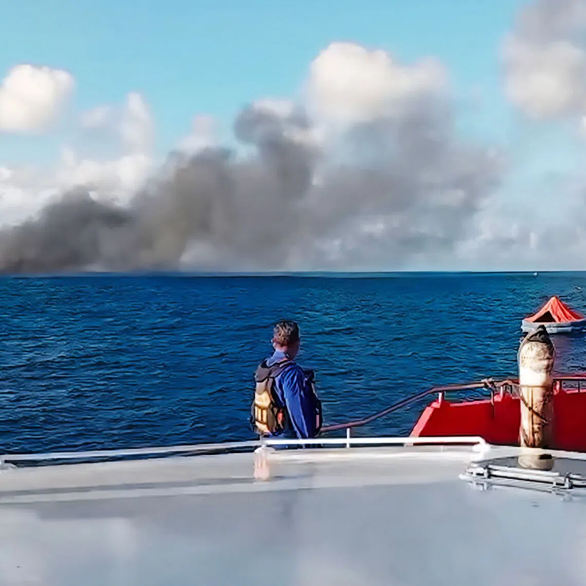 Smoke billowing from the ferry, which was headed to Bali from Lombok island when it caught fire on Aug 12.