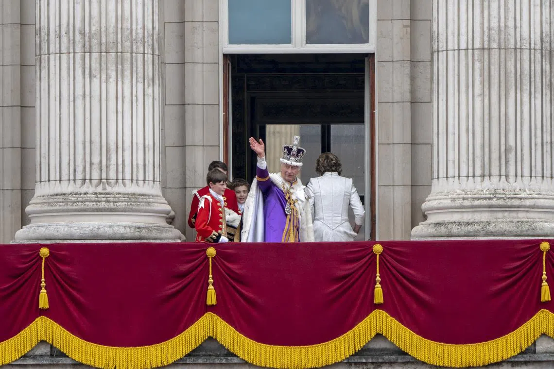 King Charles returns to the balcony at Buckingham Palace to wave once more to his subjects, after his coronation in London, on May 6, 2023. The king promised a modern coronation, but could not escape the burdens of the past.  (Andrew Testa/The New York Times)
