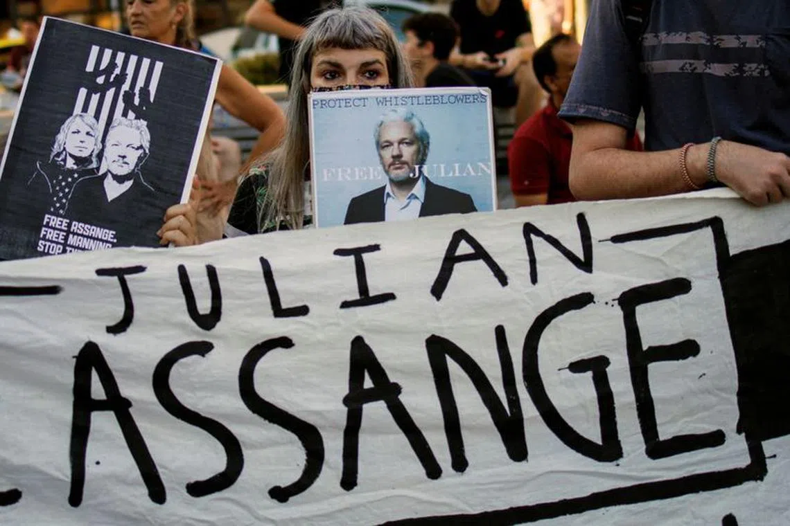 FILE PHOTO: A supporter holds a poster depicting Julian Assange during a protest against the extradition of WikiLeaks' founder from Britain to the U.S., in Athens, Greece, June 20, 2022. REUTERS/Alkis Konstantinidis/File Photo
