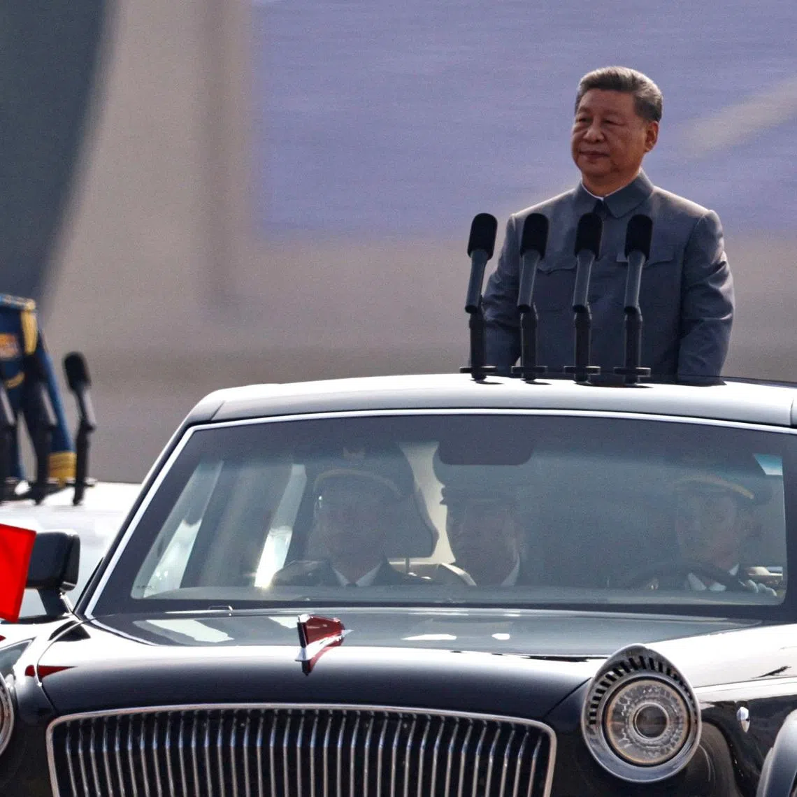 FILE PHOTO: Chinese President Xi Jinping stands in a car to review the troops during a military parade to mark the 80th anniversary of the end of World War Two, in Beijing, China, September 3, 2025. REUTERS/Tingshu Wang/File Photo