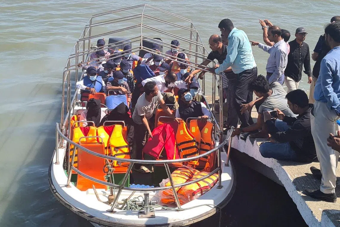 A Rohingya delegation board a boat from Teknaf jetty on May 5, 2023, to visit Myanmar's border district of Maungdow township as part of efforts to revive a long-stalled plan to return the stateless minority to their homeland. - Bangladesh officials said 20 Rohingyas and seven officials including a border guard officer were visiting two Rohingya villages, which are part of 15 villages built by the Myanmar authorities, as part of a pilot repatriation project. (Photo by AFP)