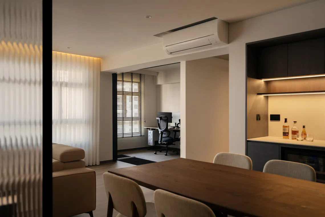 One of the bedrooms has been converted into a home office, with sliding glass doors that allow the room to be closed off from the main living area when necessary.