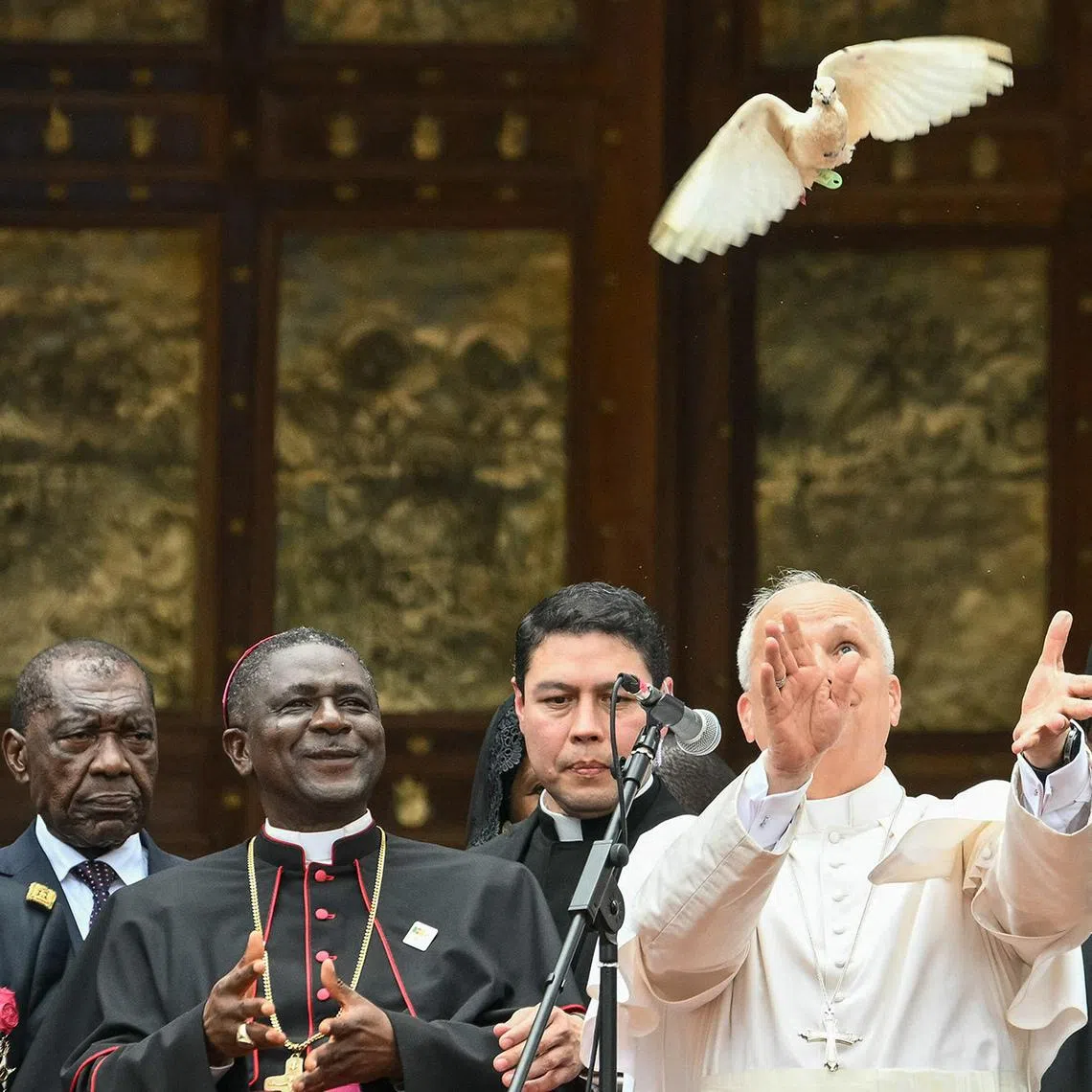 Pope Leo XIV (3rd R) releases a white dove after he met with the community of Bamenda at Saint Joseph's Cathedral in Bamenda, on the fourth day of an 11-day apostolic journey to Africa, on April 16, 2026. (Photo by Alberto PIZZOLI / AFP)