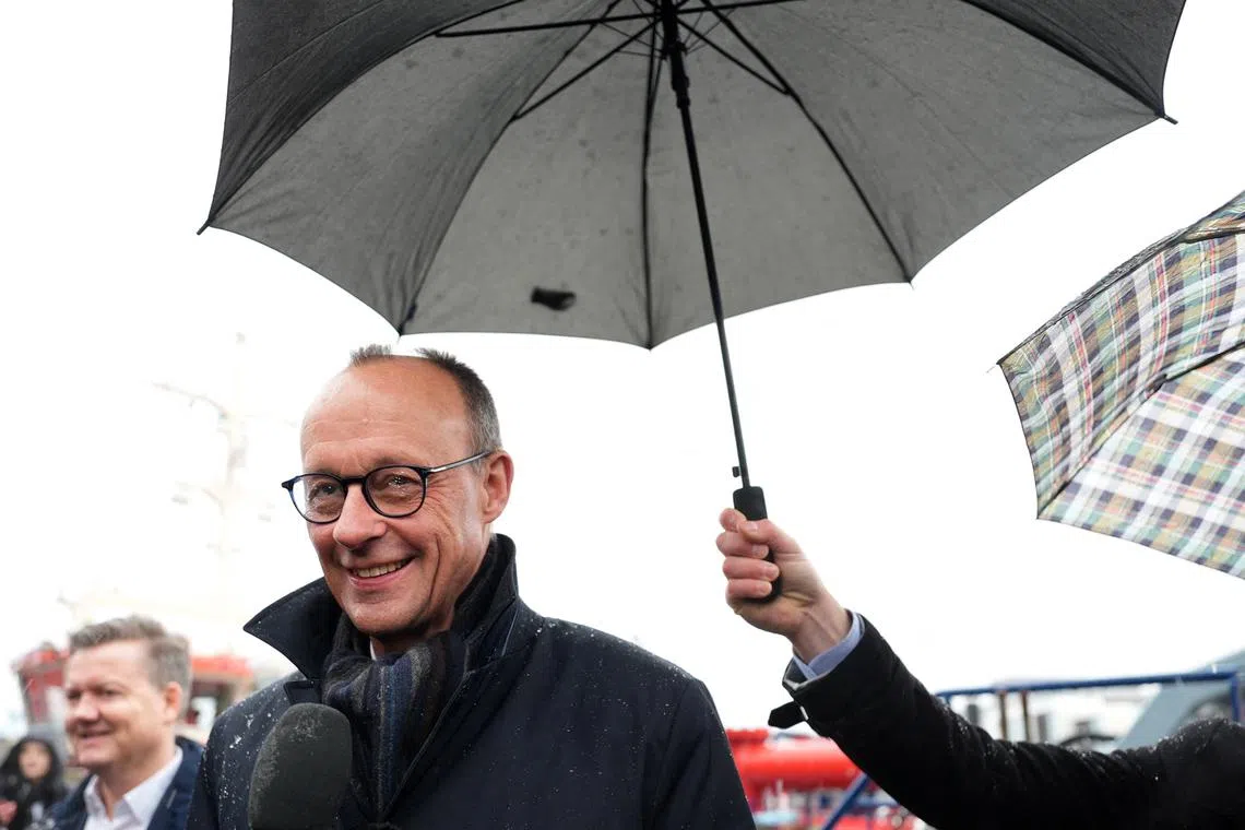 FILE PHOTO: Christian Democratic Union (CDU) leader and CDU top candidate for the upcoming general election Friedrich Merz answers journalists' questions as he visits the Hafencity in Hamburg, Germany, January 10, 2025.  Marcus Brandt/Pool via REUTERS/File Photo
