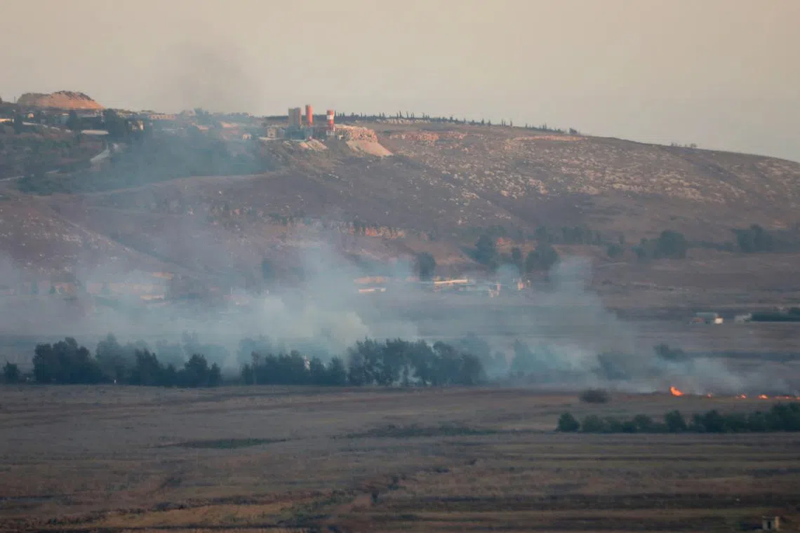 Smoke billows over southern Lebanon, amid ongoing cross-border hostilities between Hezbollah and Israeli forces, as pictured from Marjayoun, near the border with Israel, September 24, 2024. REUTERS/Karamallah Daher