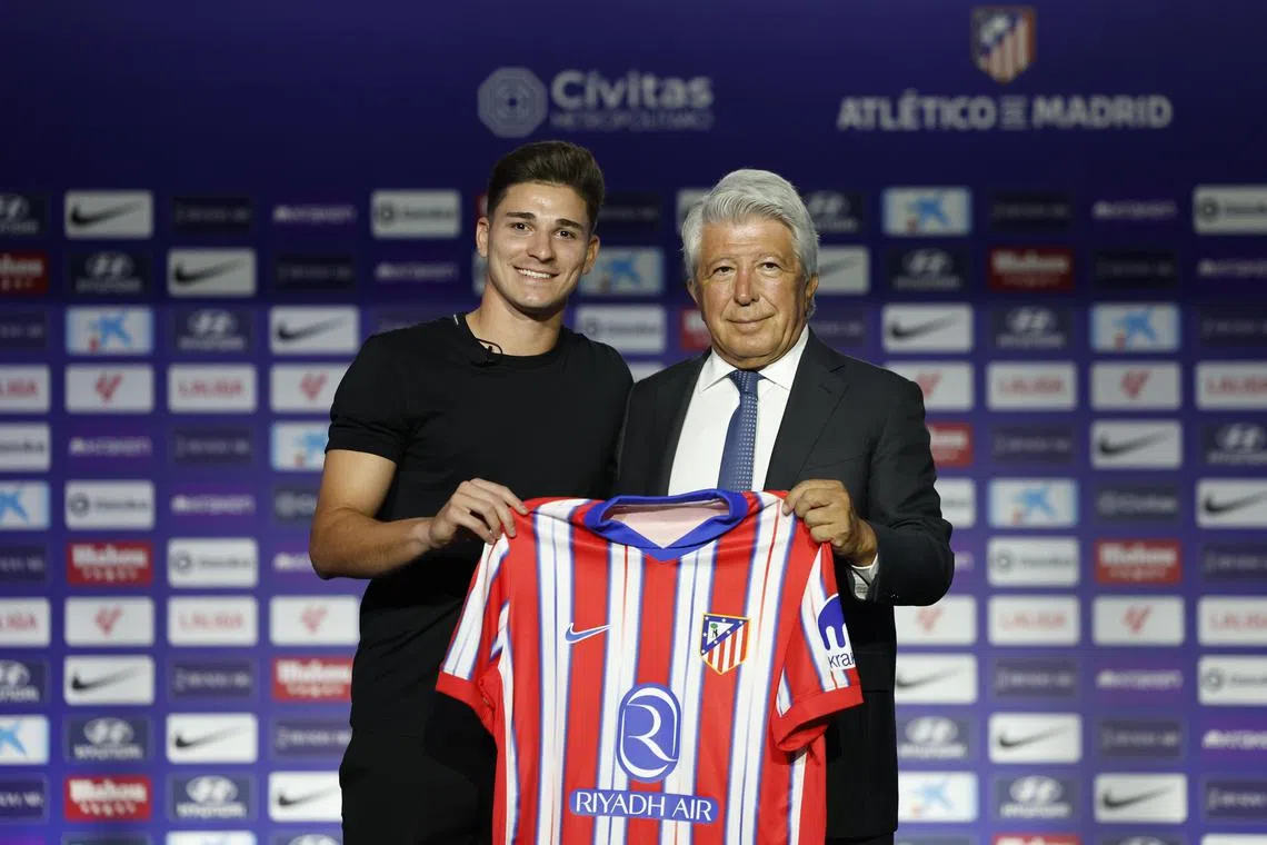 Argentinian striker Julian Alvarez with Atletico Madrid president Enrique Cerezo during his official presentation as a new player at the Civitas Metropolitano stadium in Madrid on Aug 16, 2024.