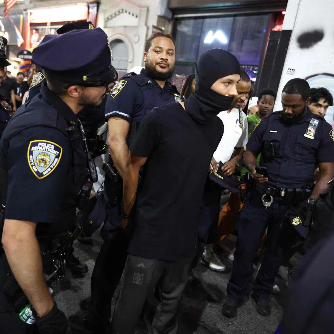 NYPD officers arrest a person as New York Knicks fans gather outside Madison Square Garden during Game 4 of the NBA Finals in New York on June 10.