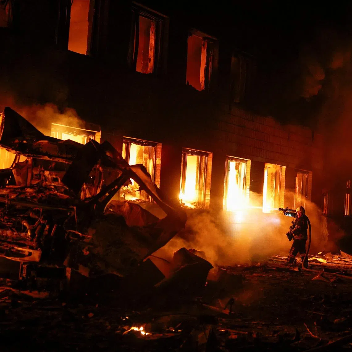 Firefighters work at a compound of a private enterprise damaged during Russian missile strikes, amid Russia's attack on Ukraine, in Kyiv, Ukraine July 16, 2026. REUTERS/Valentyn Ogirenko