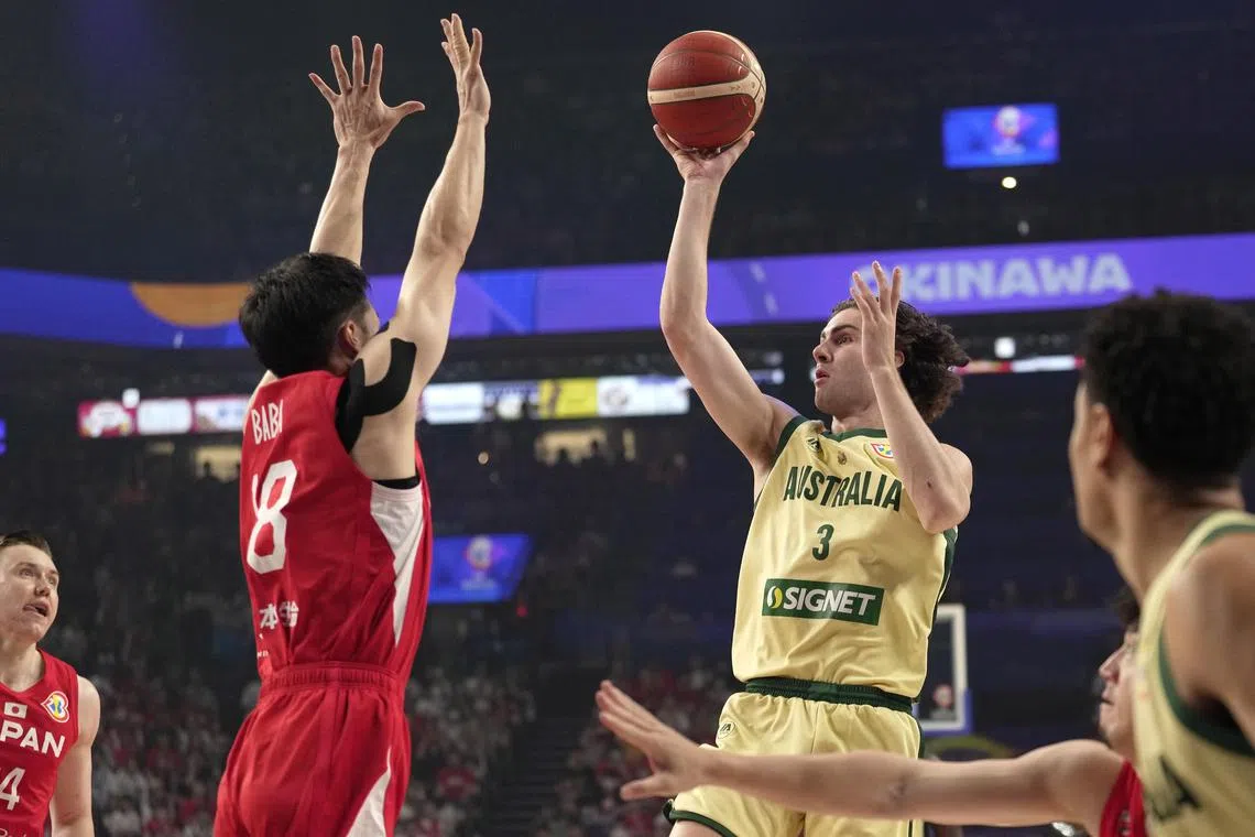 Australia's Josh Giddey shoots against Yudai Baba of Japan during their group-stage match in Okinawa. The Australians won 109-89 to advance to the next round.