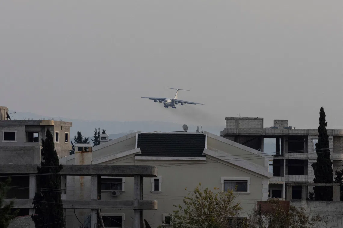 FILE PHOTO: A Russian military aircraft approaches the Hmeimim air base in Syria's coastal Latakia, Syria, December 15, 2024. REUTERS/Umit Bektas/File Photo