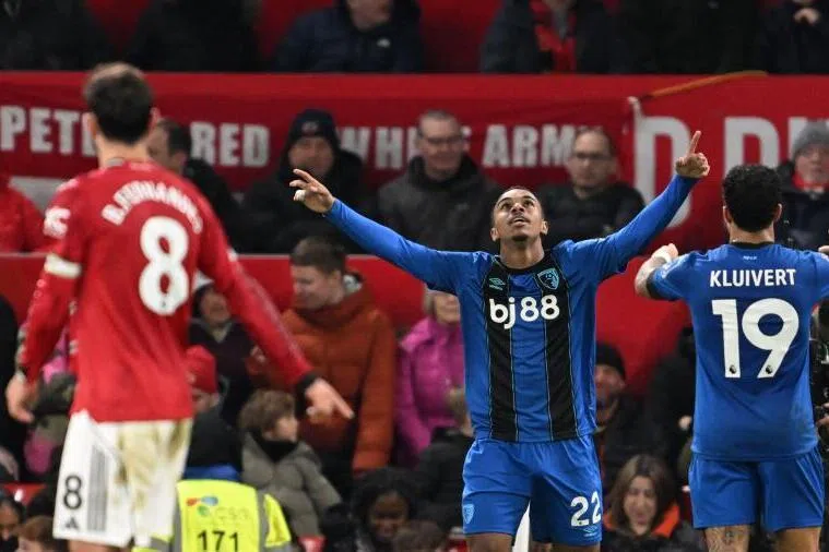 Bournemouth's French striker Eli Junior Kroupi (centre) celebrates scoring their fourth goal during the English Premier League football match against Manchester United.