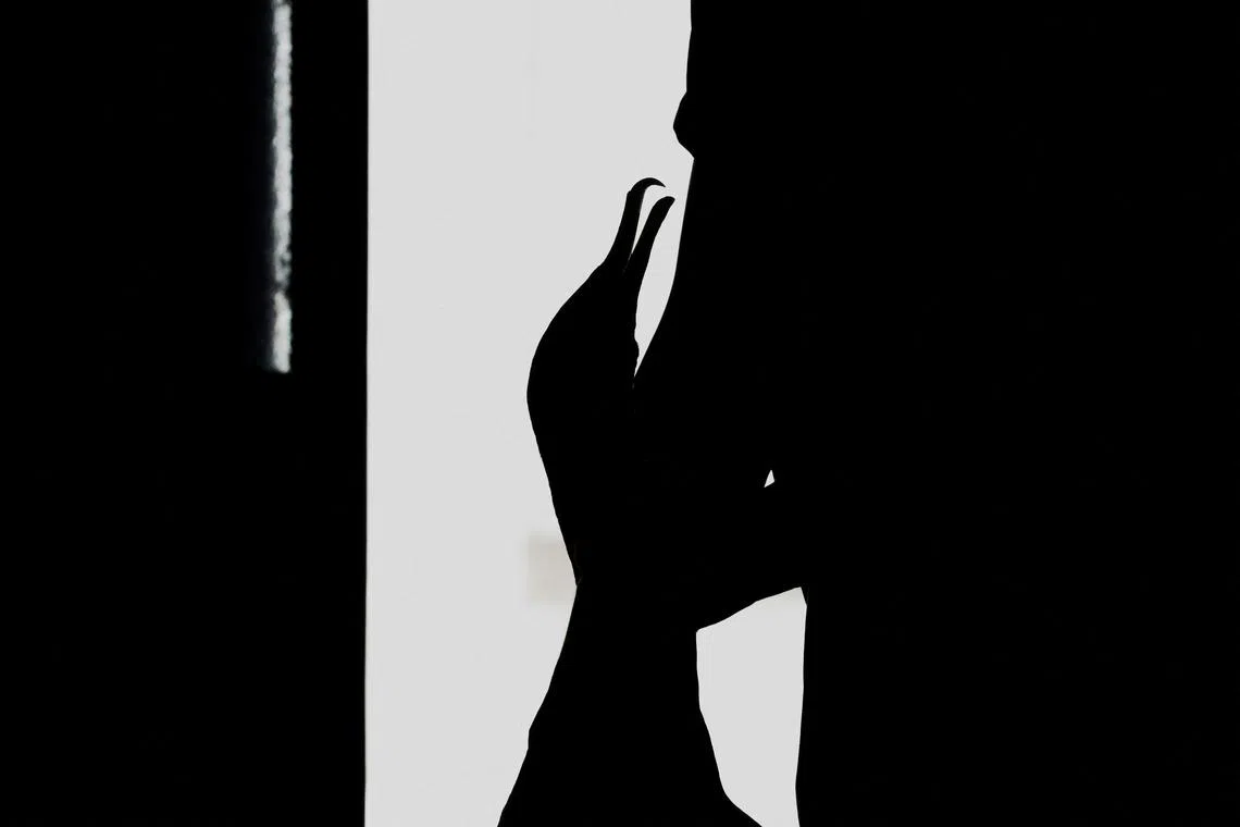 Cormorant fishing master, known as usho, Youichiro Adachi, 48, stroking his bird's neck during a daily physical check-up to confirm its health and maintain their bond, at home in Oze, Seki, Japan, Sept 9, 2023. 
With cormorants being a constant presence in his life, Adachi is the 18th generation of his family to be a usho and one of about 50 people in Japan carrying on the 1,300-year tradition of using trained birds to dive for fish. "For me, cormorants are my partners," he said.      