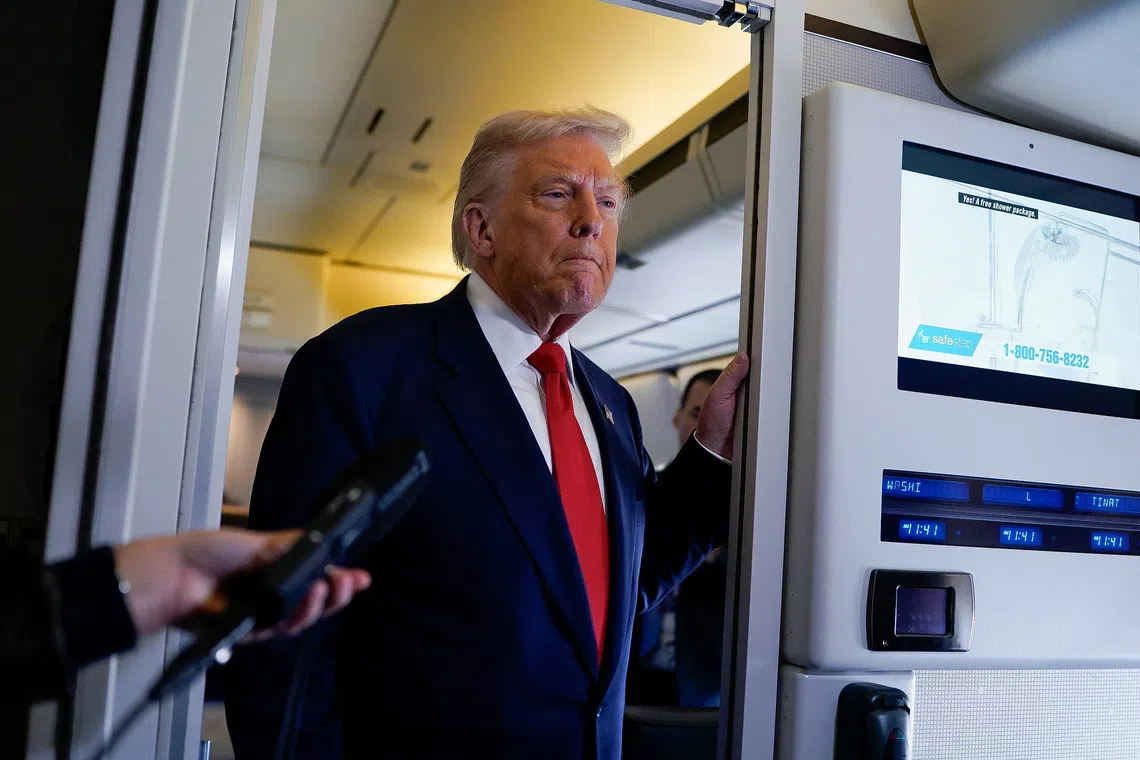 U.S. President Donald Trump looks on as he speaks to members of the media aboard Air Force One as he departs for Florida from Joint Base Andrews, Maryland, U.S., October 31, 2025. REUTERS/Elizabeth Frantz