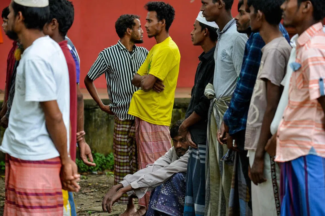 Rohingya refugees gather for identity checks at a temporary shelter following their arrival by boat in Laweueng, Aceh province on December 27, 2022. 