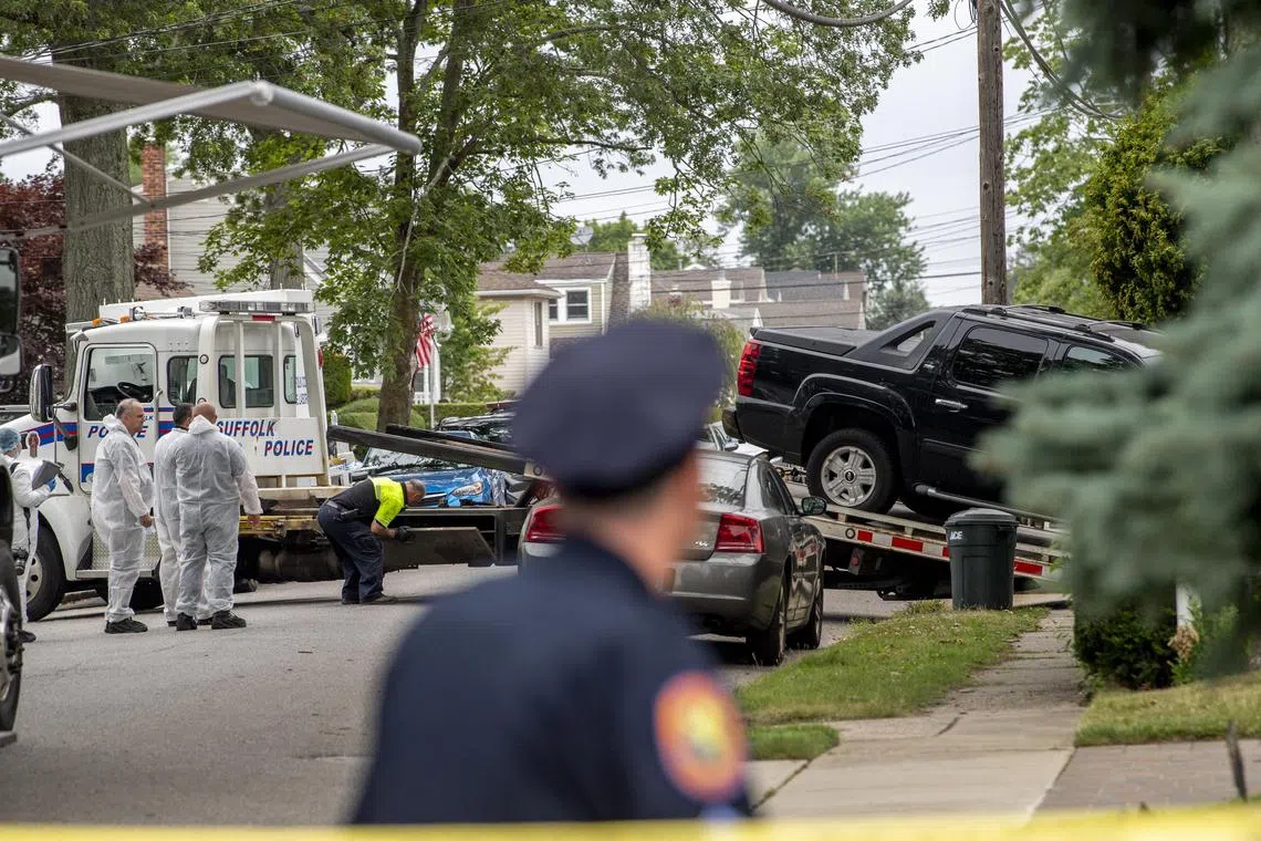 Police tow a Chevy Avalanche from the home of suspect Rex Heuermann.