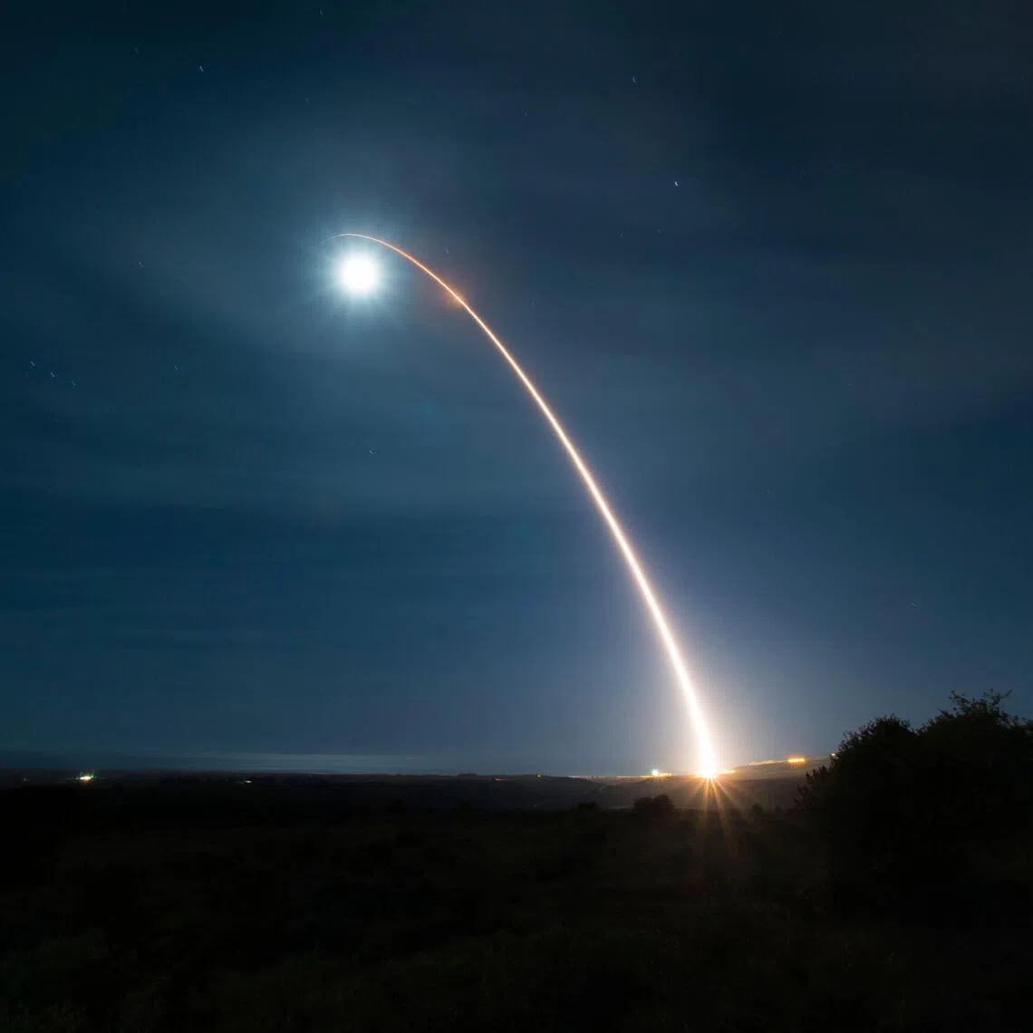 (FILES) This US Air Force handout photograph shows an unarmed Minuteman III intercontinental ballistic missile as it launches during a developmental test at 12:33 a.m. Pacific Time on February 5, 2020, at Vandenberg Air Force Base, California. Russia vowed on February 4, 2026,  to act "responsibly" should its last nuclear treaty with the United States expire on February 5, amid mounting fears the agreement's collapse could spur a new arms race between the top nuclear powers. The New START agreement, signed in 2010, limits the number of nuclear warheads each side can deploy. (Photo by Clayton WEAR / US AIR FORCE / AFP) / RESTRICTED TO EDITORIAL USE - MANDATORY CREDIT "AFP PHOTO /US AIR FORCE /CLAYTON WEAR/ HANDOUT " - NO MARKETING - NO ADVERTISING CAMPAIGNS - DISTRIBUTED AS A SERVICE TO CLIENTS